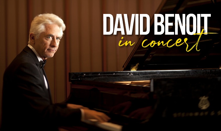 David Benoit seated at a grand piano.