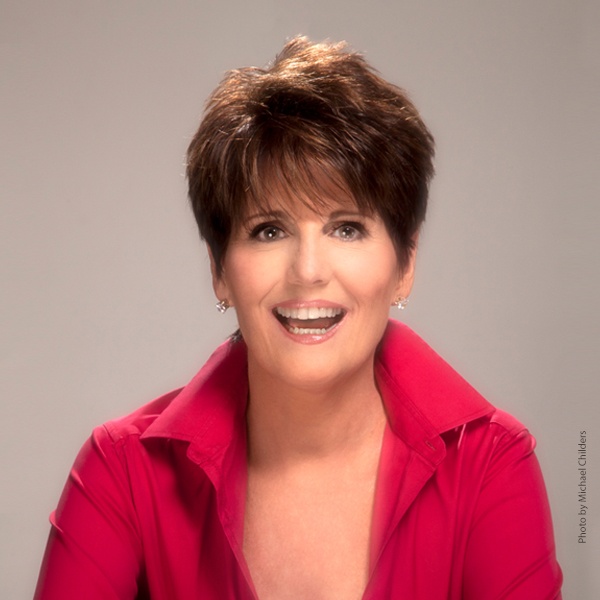 Lucie Arnaz in a red top, smiling