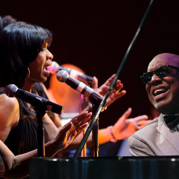 "Ray" at the piano, with one off his backup singers beside him.
