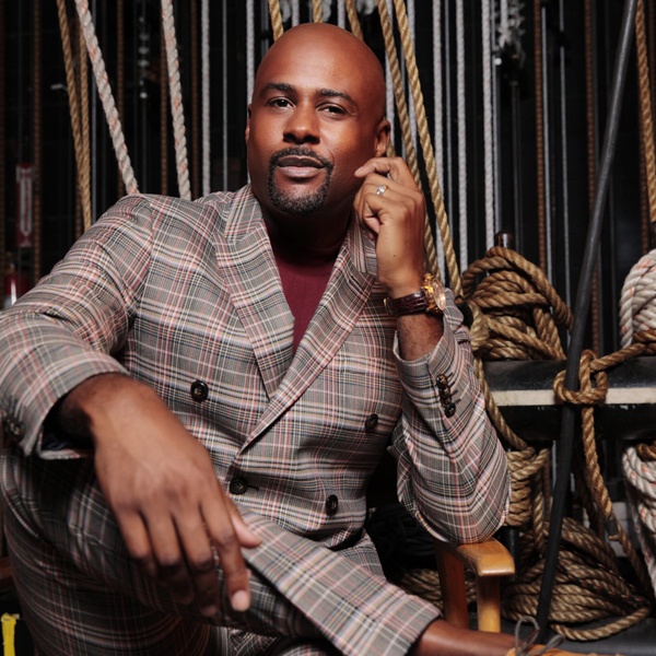 Terron Brooks seated backstage, stage rigging in the background