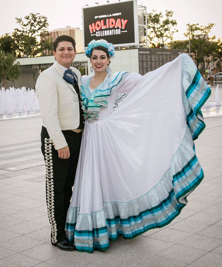 Kareli and Jimmy posing in costume and smiling.