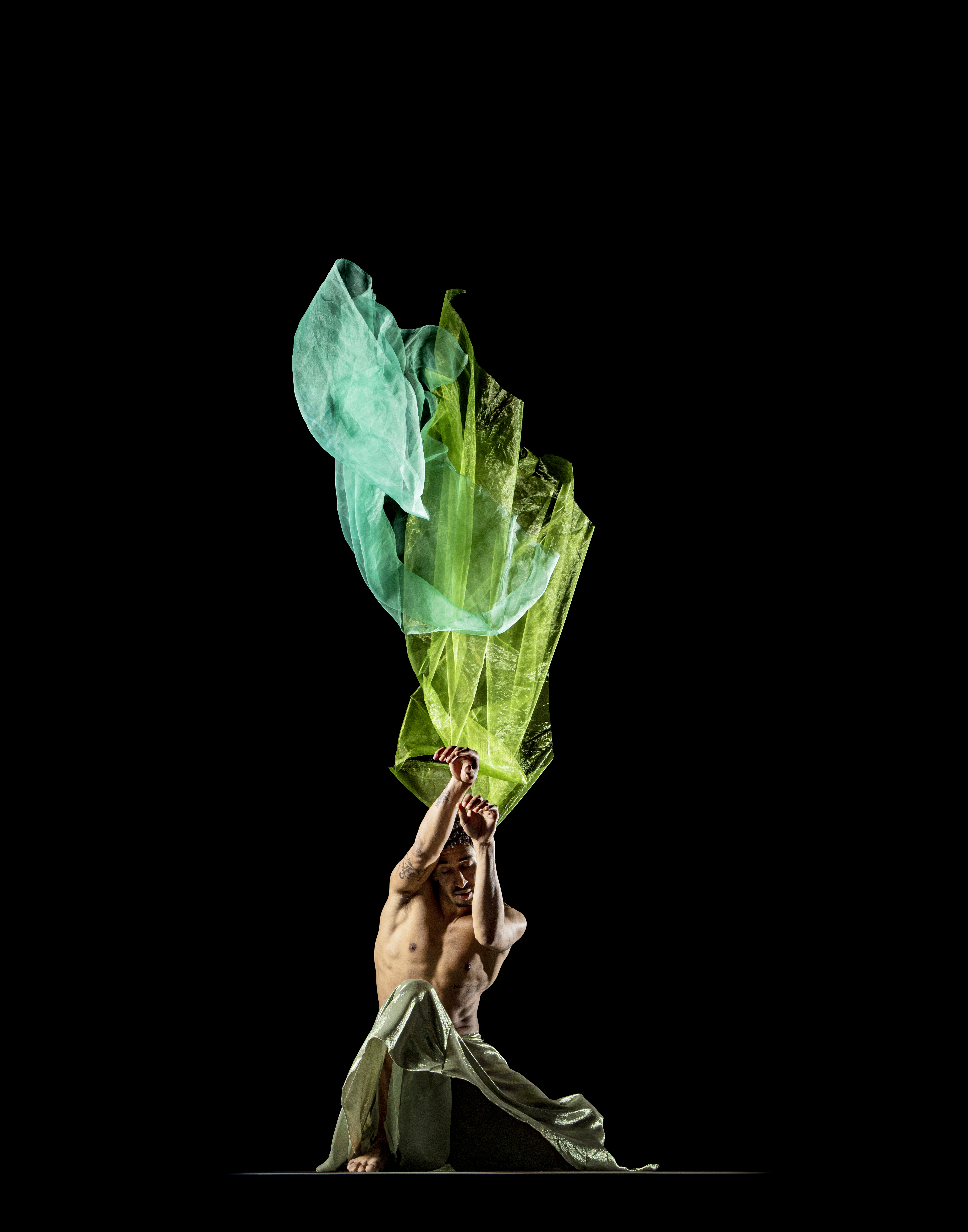 Shuaib Elhassan dancing against a dark background.