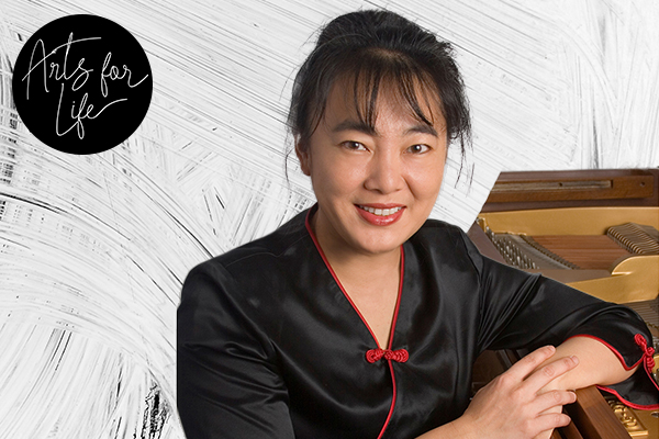 Tien Hsieh seated at a piano.