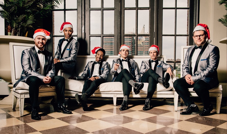 The Doo Wop Project members wearing tuxes and with Santa hat