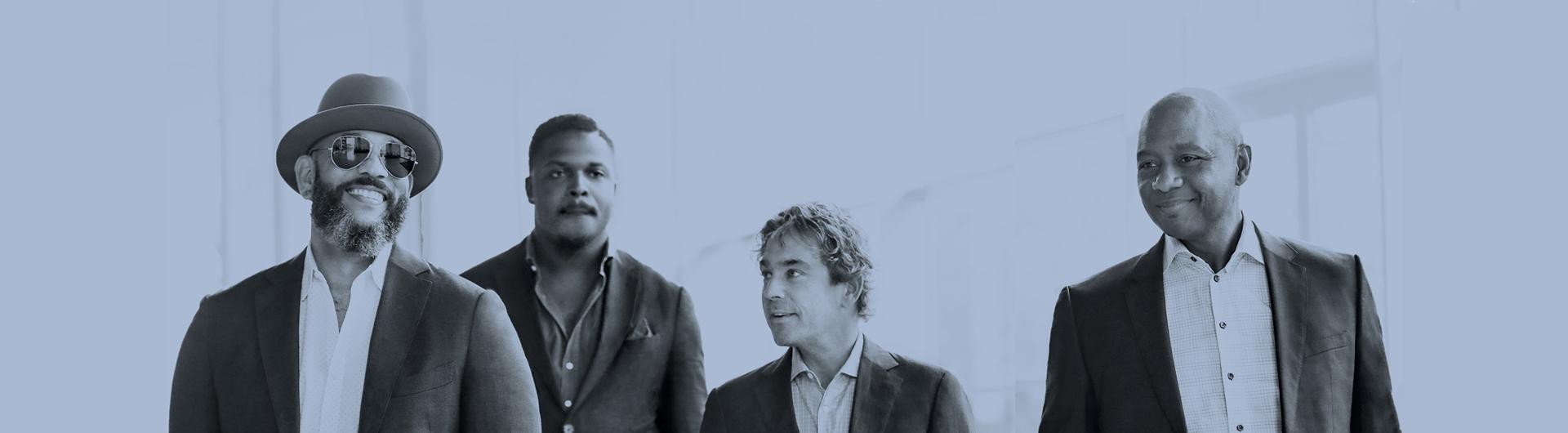 The members of the Branford Marsalis Quartet smiling in a stylized blue image.