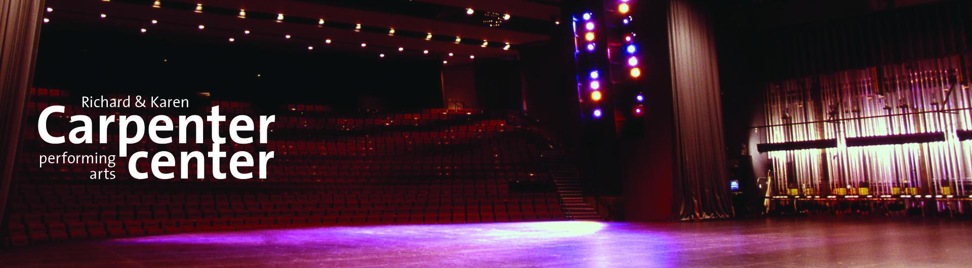 A view of the Carpenter Center's stage toward the darkened house. The Center's logo appears on the left side.