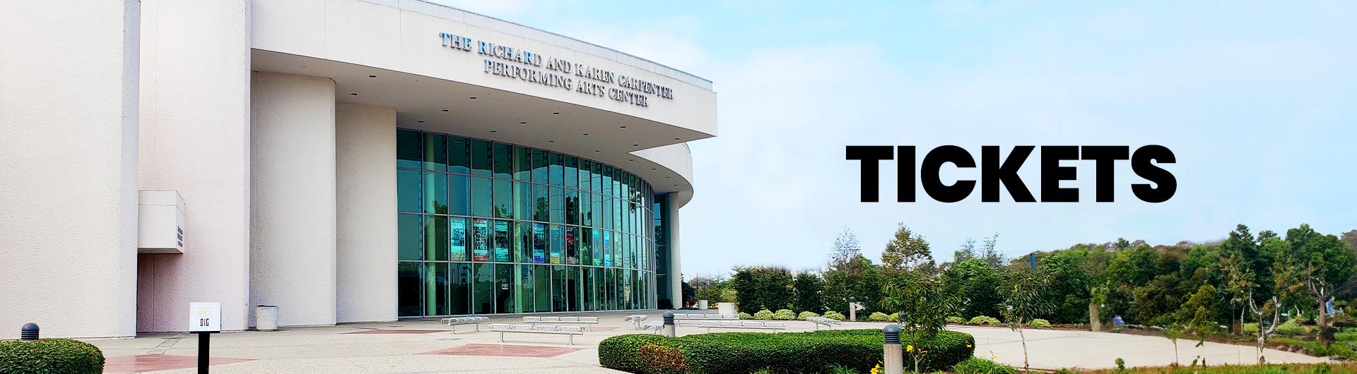 The exterior of the Carpenter Center. The word TICKETS appears against the blue sky.