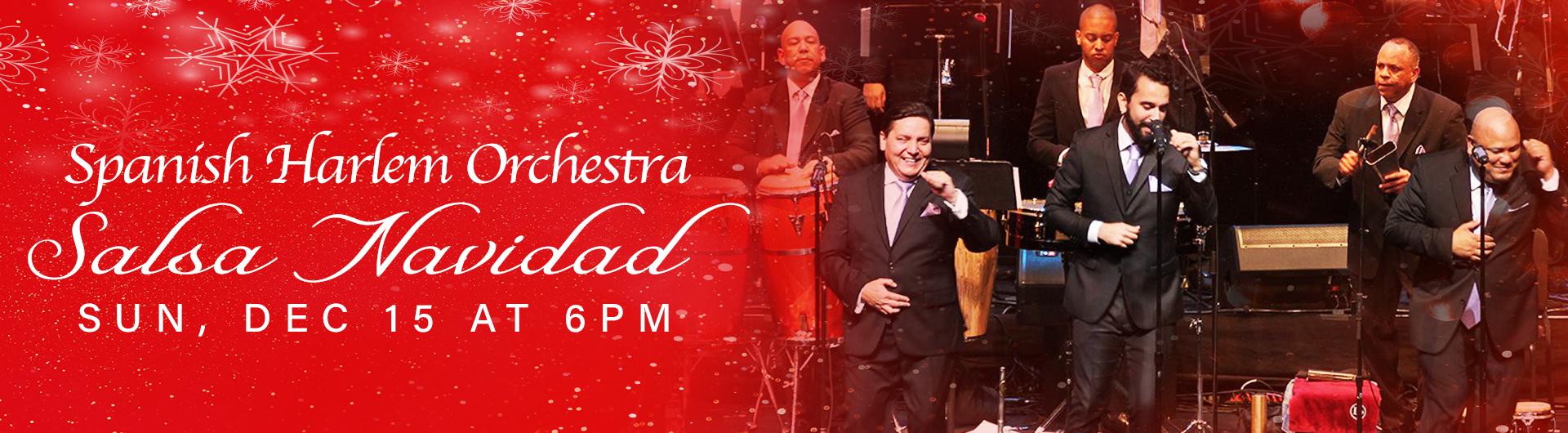 Members of Spanish Harlem Orchestra on stage beside a headline Salsa Navidad