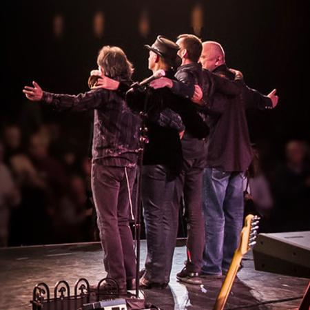Members of Hotel California on stage after taking a bow.