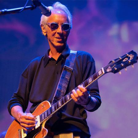 Elliot Lurie on stage playing electric guitar