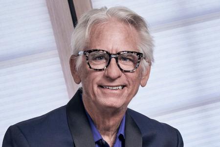 David Benoit wearing glasses and smiling.