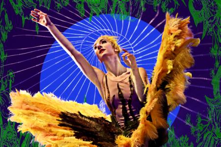 A member of Momix with her hand outstretched against a colorful backdrop