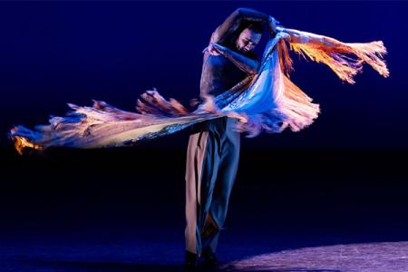 A member of Flamenco Vivo Carlota Santana on a dark stage